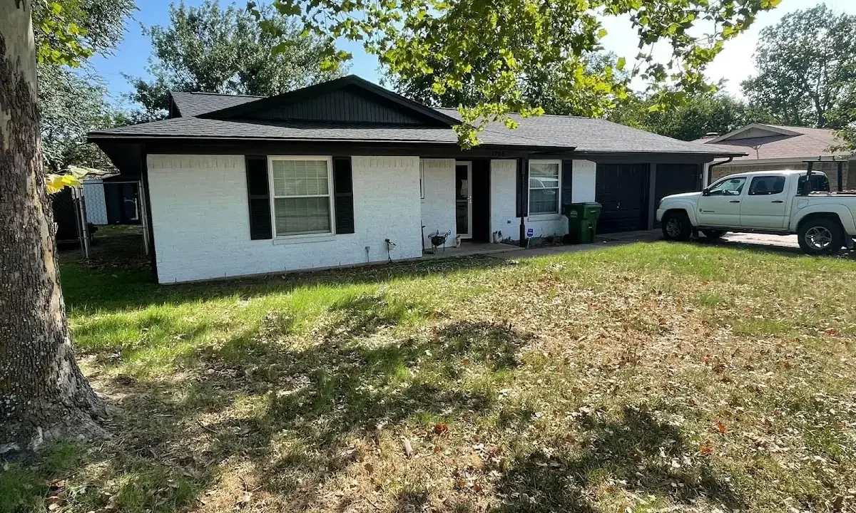 Professional roofing crew working on a residential roof in Gustine